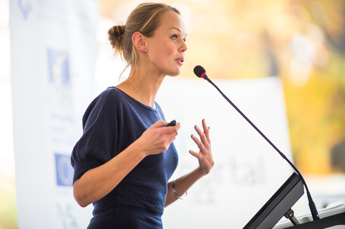Pretty, young business woman giving a presentation in a conferen