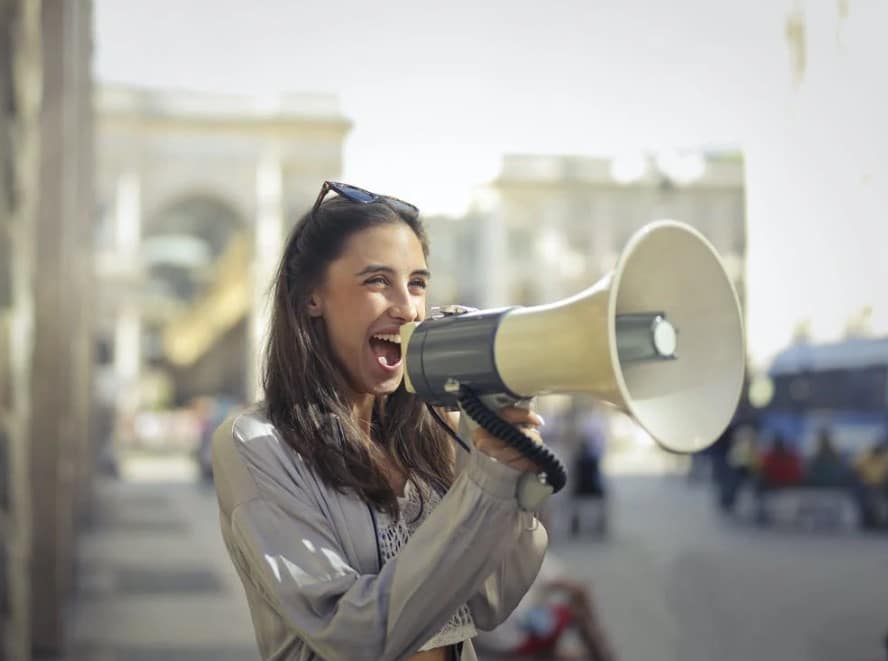 Businesswomen using a megaphone to magnify her voice
