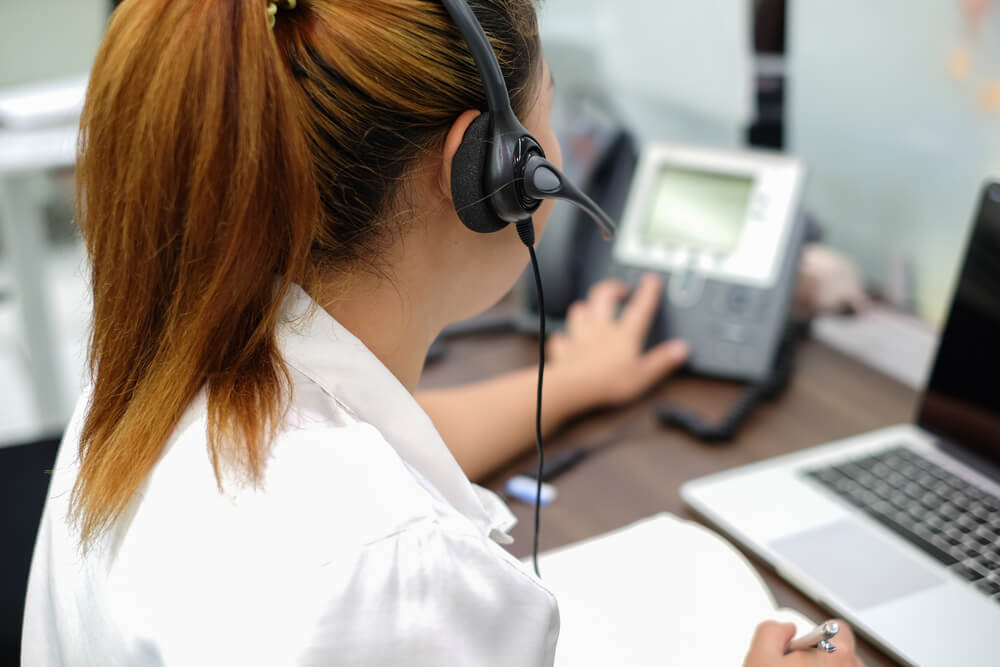 A Woman Press Number on Telephone and Response on the Phone