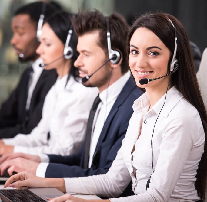 Side View of Line of Call Centre Employees Are Smiling and Working on Computers.